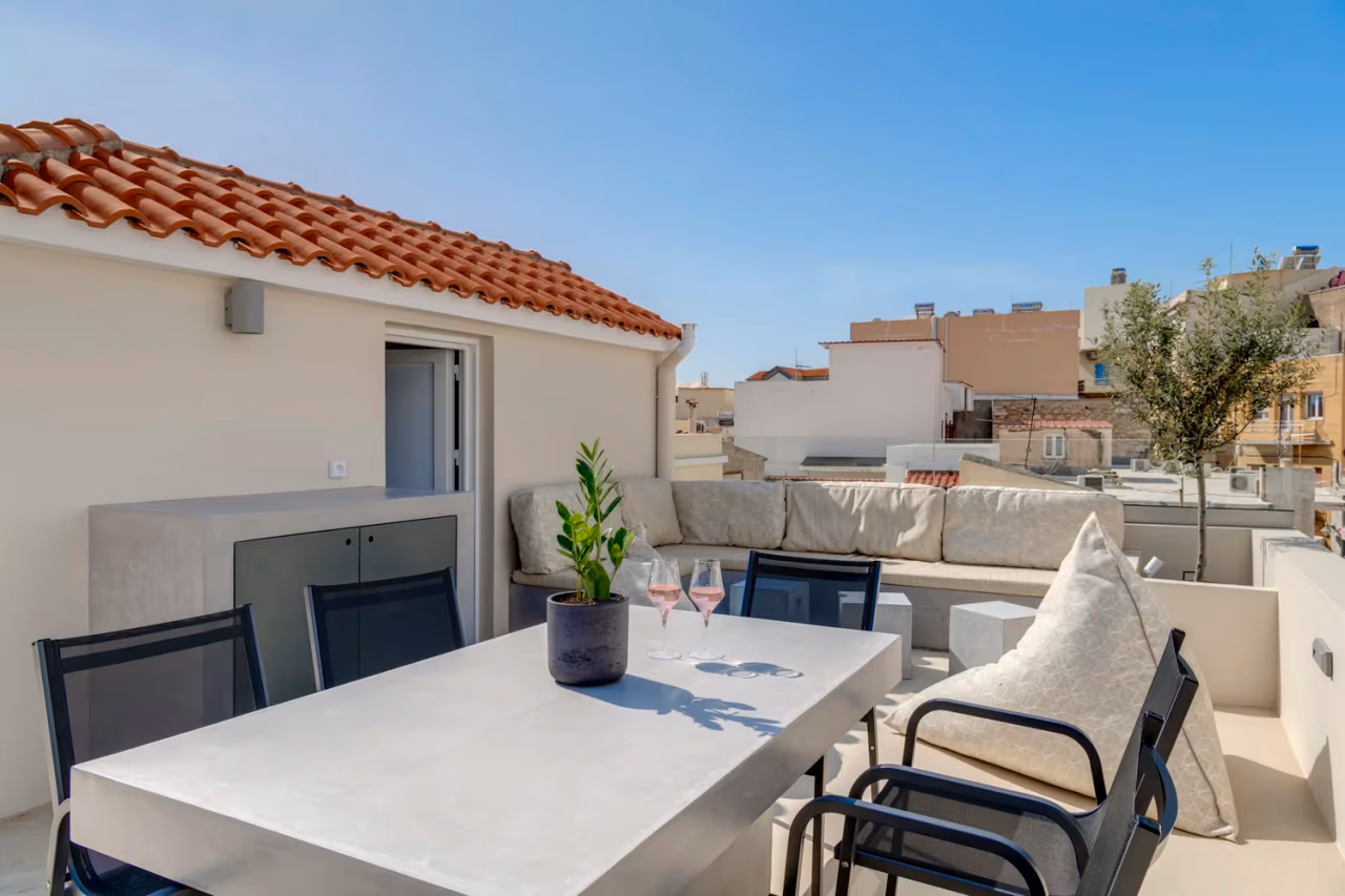 Outdoor dining table, cabinet and seating on the upper terrace