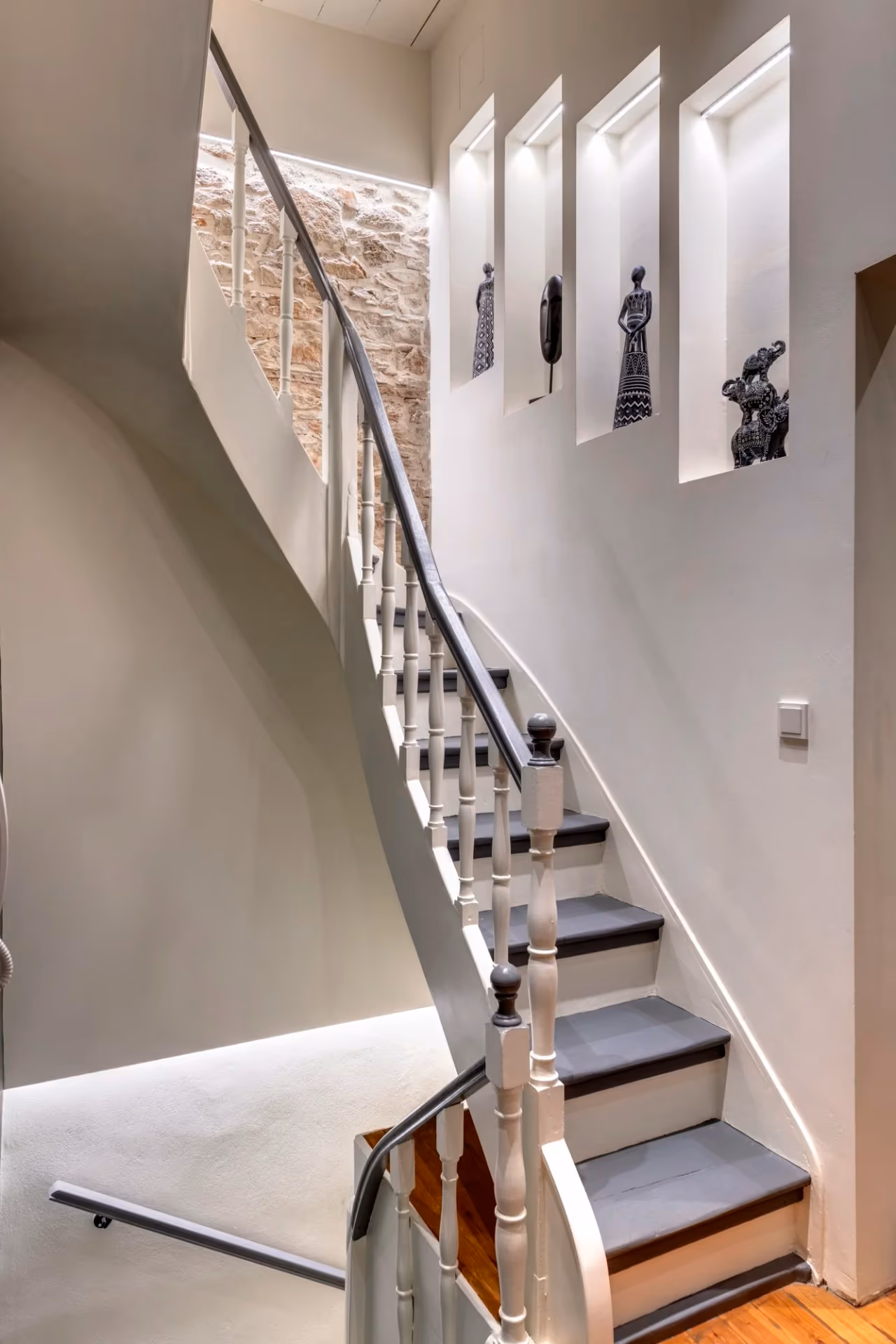 Staircase with timber treads and illuminated display niches