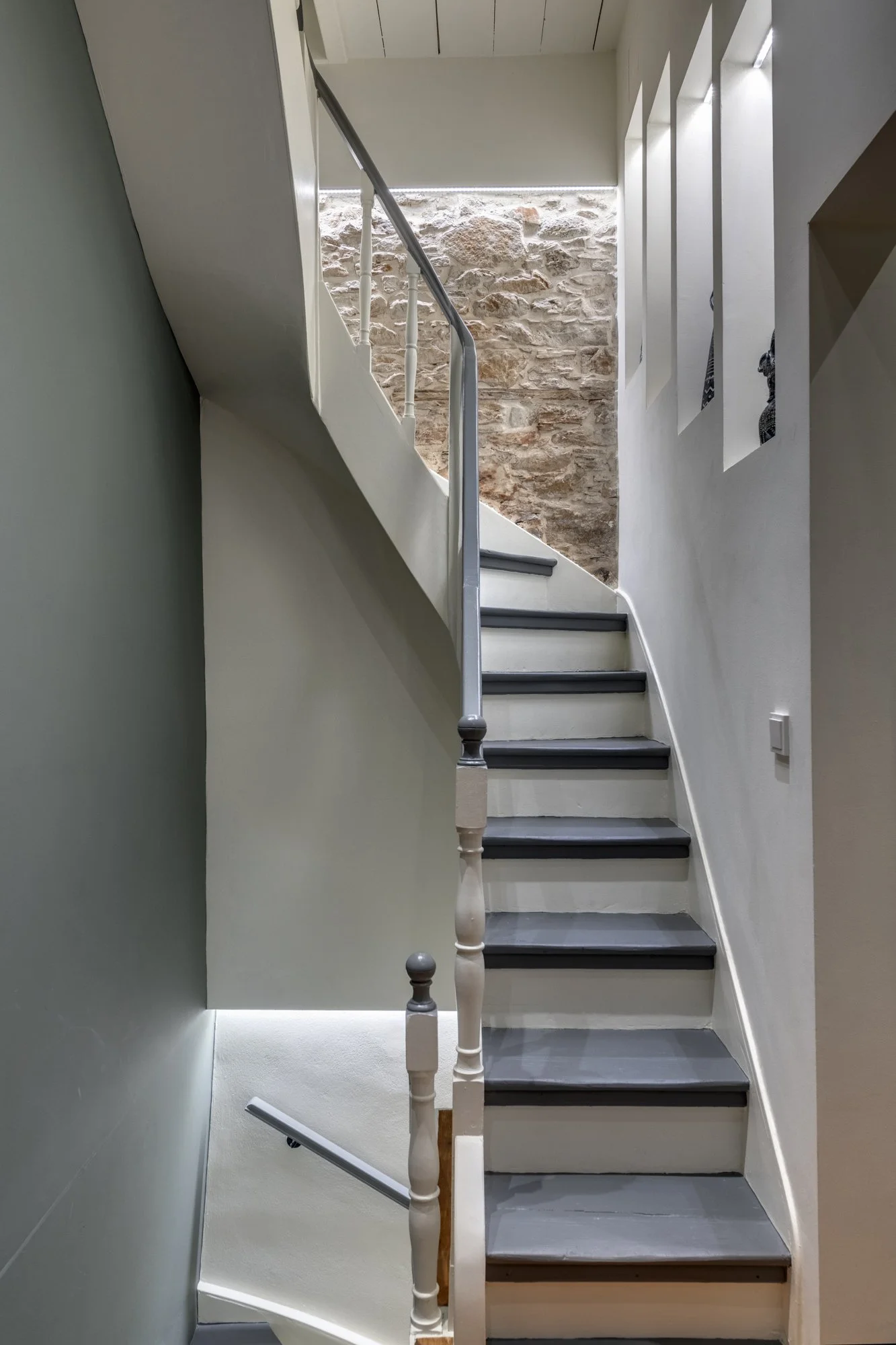 Curved interior staircase with patterned floor tiles